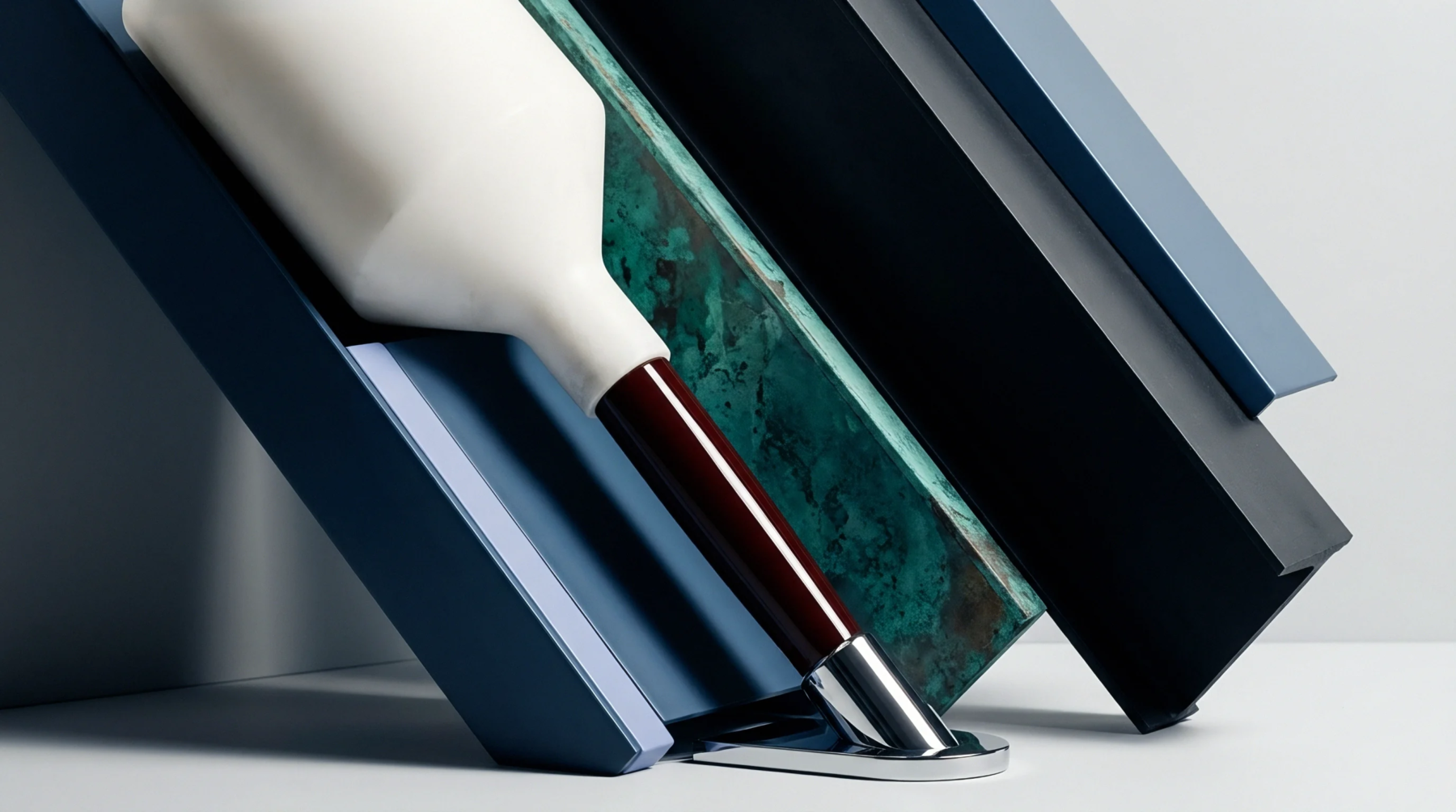 Painted aluminum extrusion profiles and patinated stone finish samples are arranged alongside a ceramic component on a neutral studio surface.
