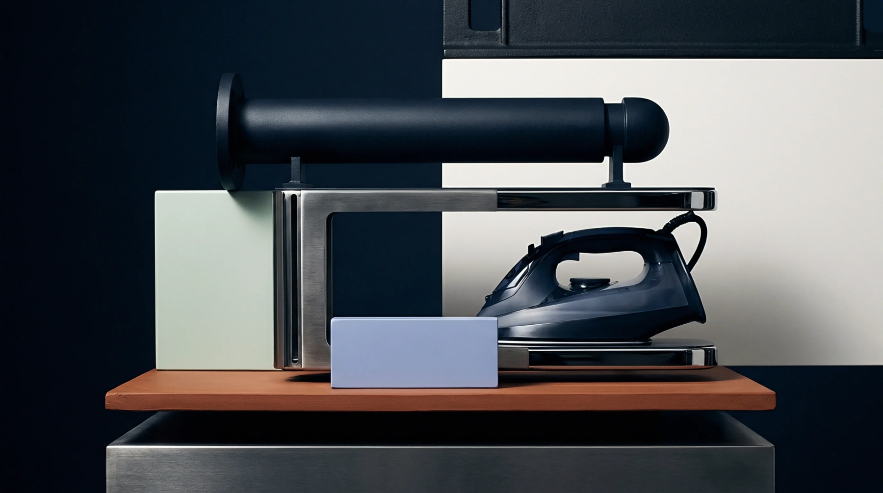 Metallic industrial hardware and molded polymer consumer goods components sit arranged on a terracotta surface within a studio facility.