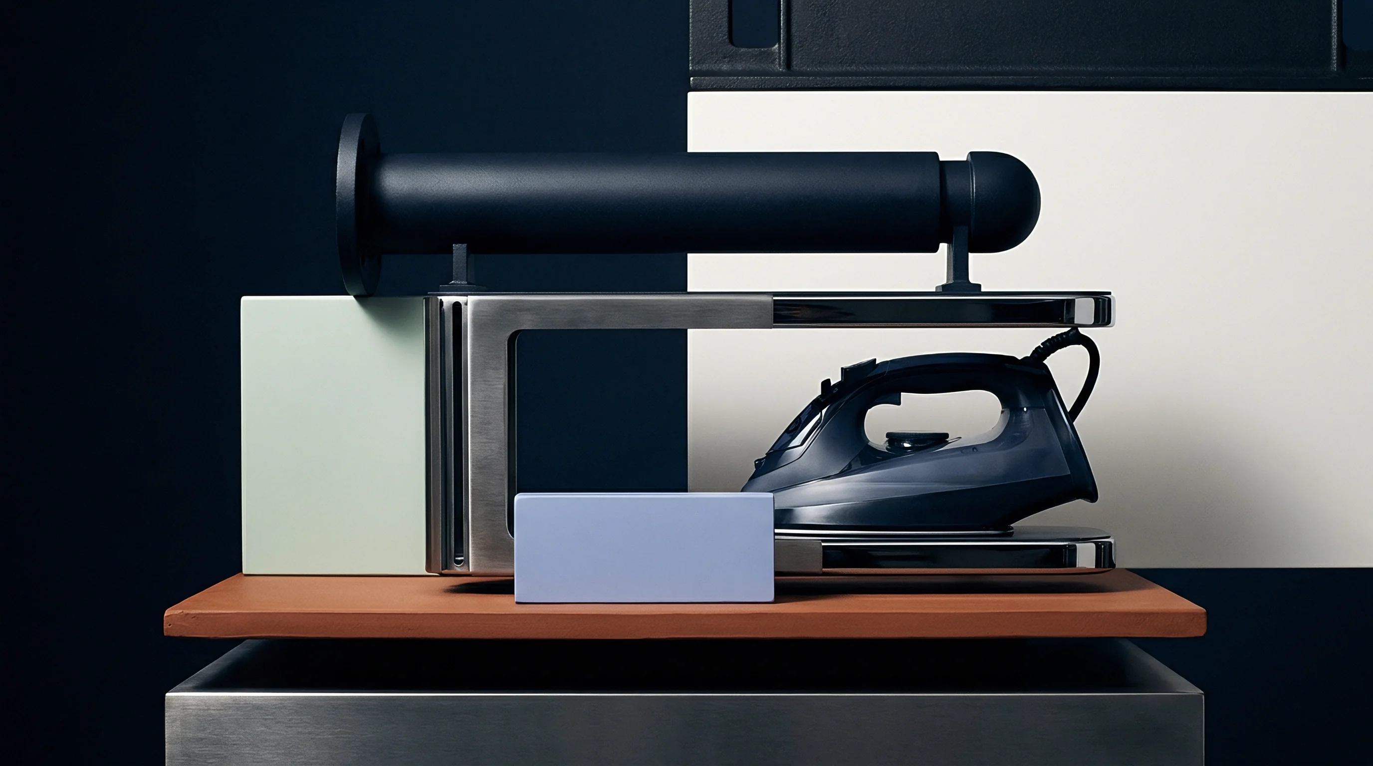 Metallic industrial hardware and molded polymer consumer goods components sit arranged on a terracotta surface within a studio facility.
