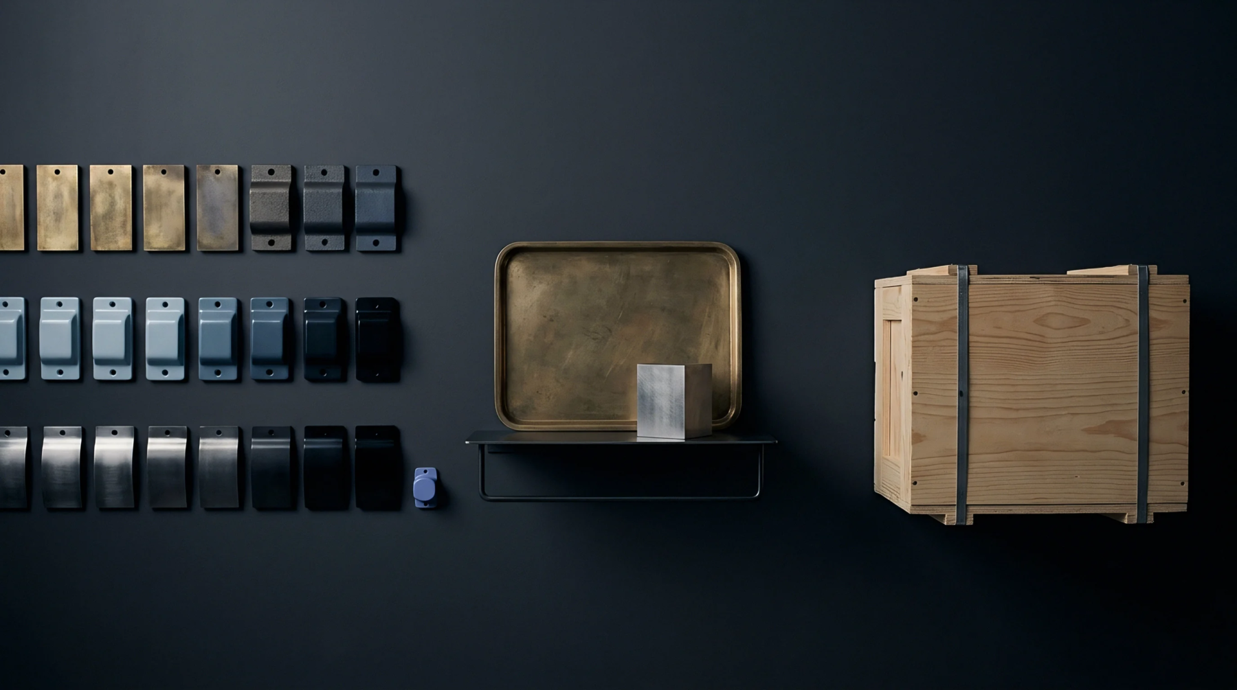 Rows of industrial component samples display diverse metal finishes and materials alongside a brass tray and a wooden shipping crate.